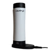 The Cauldryn Variable Temperature Beverage Warmer by PahaQue Wilderness is a tall, white, cylindrical electric appliance with black accents, upright on its circular charging dock connected by a cord.