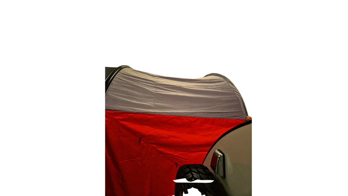 A NuCamp TAB 360 Trailer Awning by Paha Que Custom acts as a waterproof shelter, set up at night and attached to a vehicle with a spare tire and side mirror visible in the darkness.