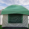 The Paha Que Custom 10x10 Side Mount Screen Room Tent is set up by a white travel trailer on grass, with trees and a partly cloudy sky, creating an ideal outdoor living space for camping and adventures.