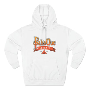 The PahaQue Unisex Premium Pullover Hoodie in white by Printify features BahaQue Wilderness in yellow and red, a triangle tent graphic, and Est. 1957 on the front center. Fleece lining offers extra comfort for cooler days.