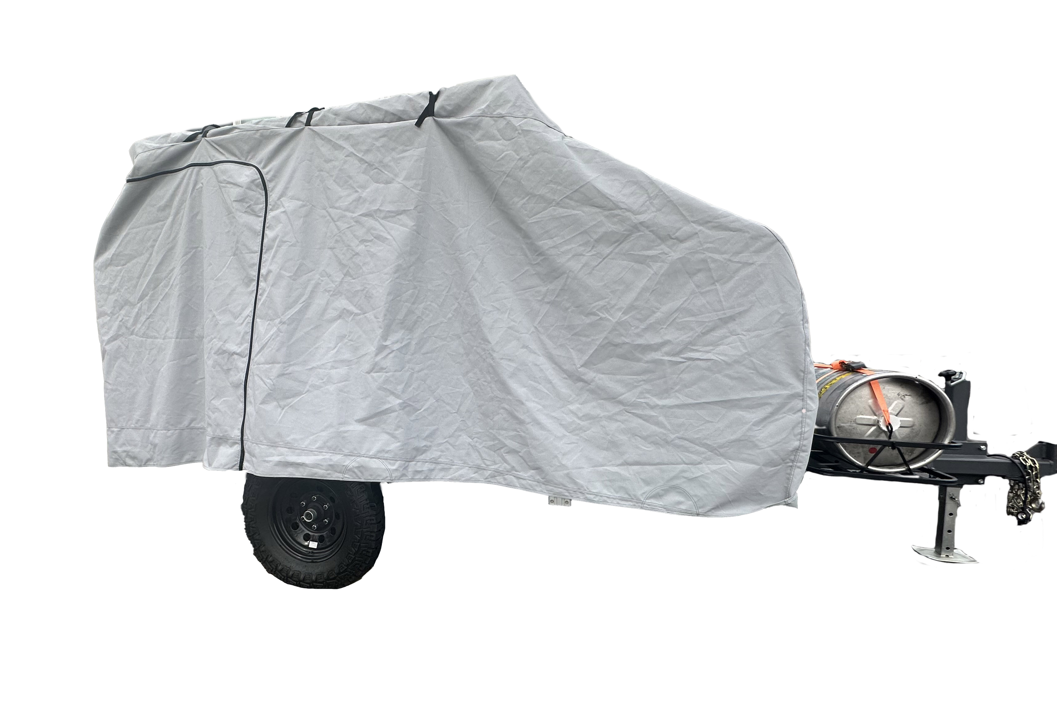 A Campinawe Trailer covered with the PahaQue Custom Heavy Duty MagnaTuff Fabric Trailer Cover features weather-proof, breathable material, a zippered side door, and reveals the metal tank, tow hitch, and black wheels at the front.