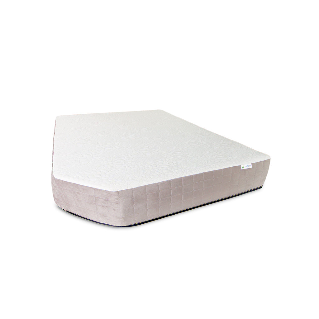 The Journey Mattress by Paha Que Custom is a white and light beige, irregularly trapezoidal economy mattress with medium firm support, displayed against a plain white background.