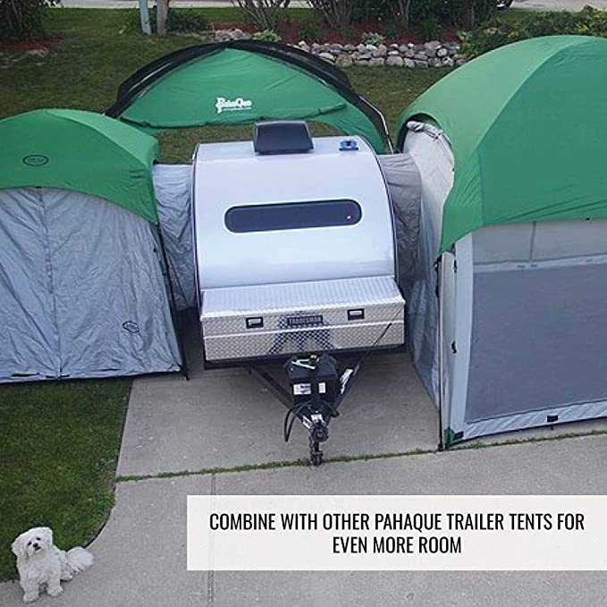 A small silver teardrop trailer is set between two Paha Que Custom 10x10 Side Mount Screen Room Tents on a driveway, with a white dog sitting nearby. Combine with other PahaQue gear for extra outdoor living space.
