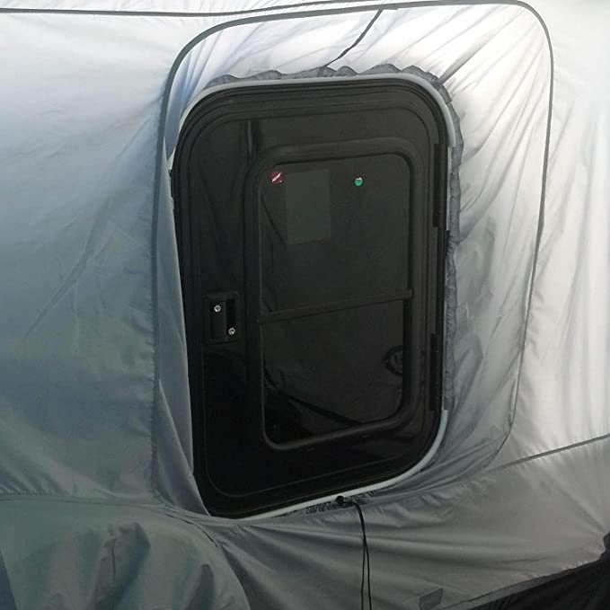 A close-up of a black RV door with a window, installed in the Paha Que Custom 5x7 Trailer Side Tent Screen Room for Camping and Outdoor Adventures. The enclosure fabric fits snugly, adding extra comfort to your camping setup.
