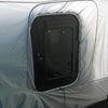 A close-up of a black RV door with a window, installed in the Paha Que Custom 5x7 Trailer Side Tent Screen Room for Camping and Outdoor Adventures. The enclosure fabric fits snugly, adding extra comfort to your camping setup.