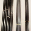 Three bundles of black poles, possibly fiberglass, are tied with rubber bands and arranged vertically on a light surface. The right bundle, part of the Paha Que Custom 10x10 Side Tent Complete Pole Set for SR10N-A Screen Room Tent, has silver ends.