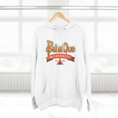 The PahaQue Unisex Premium Pullover Hoodie in white by Printify hangs on a hanger, featuring a wilderness logo with a tent graphic and Est. 1997 in red and orange tones. Its cozy fleece lining is ideal for chilly days.
