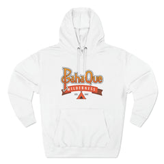 The PahaQue Unisex Premium Pullover Hoodie in white by Printify features BahaQue in yellow and orange, Wilderness in red on a ribbon, Est. 1957 above a small black tent graphic, and a soft fleece lining for added comfort.