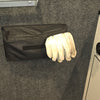 A pair of white work gloves partially stick out of PahaQue Gear Pouches by PahaQue Wilderness, which are mounted on a gray felt wall beside a control panel, offering an efficient trailer gear storage solution.