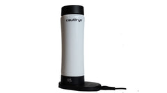 The Cauldryn Variable Temperature Beverage Warmer by PahaQue Wilderness is a tall, white, cylindrical electric appliance with black accents, upright on its circular charging dock connected by a cord.