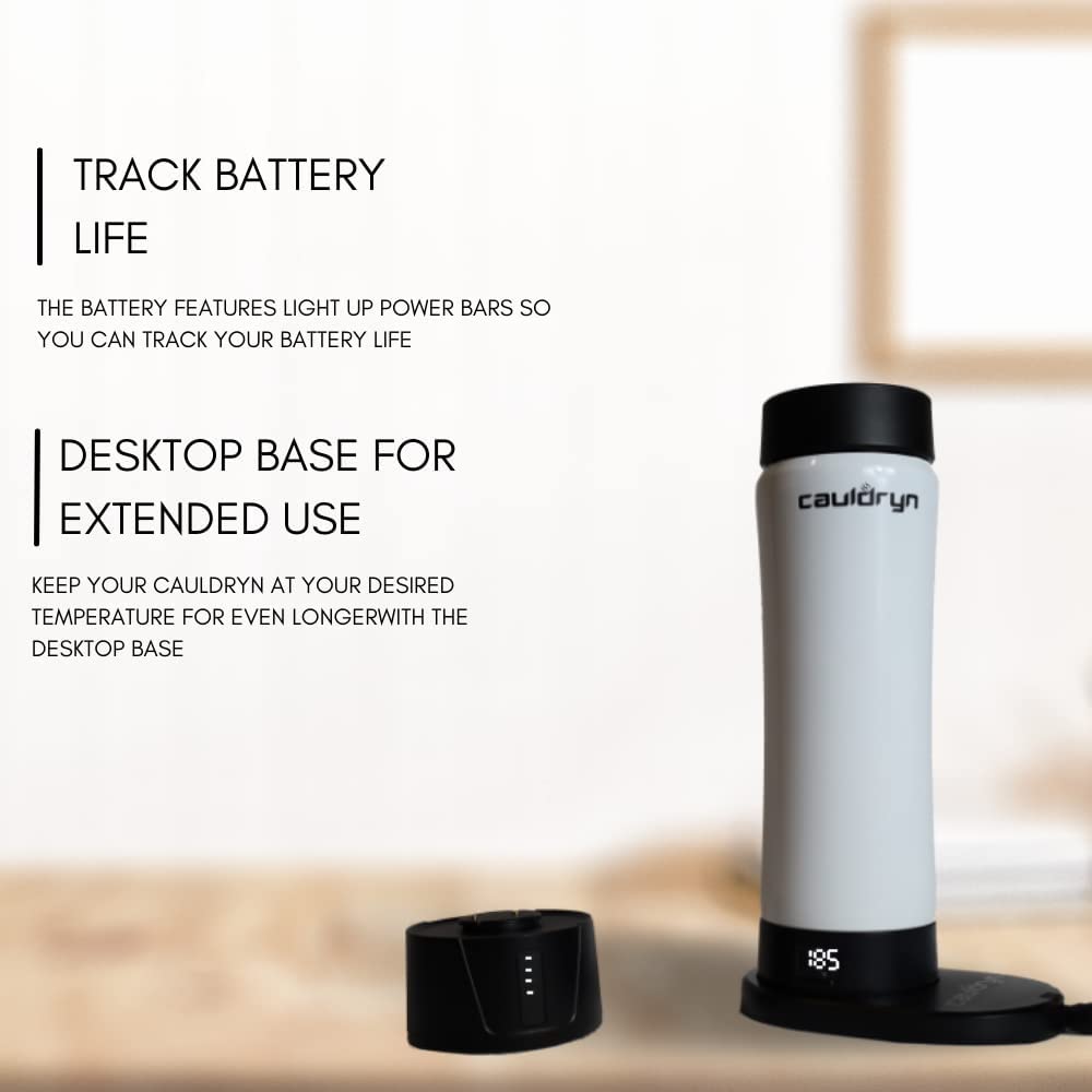 A PahaQue Wilderness Cauldryn Coffee Pro temperature control mug stands on its charging base, with another beside it. Text highlights battery life tracking and a desktop base for extended use, set against a blurred, minimalistic background.