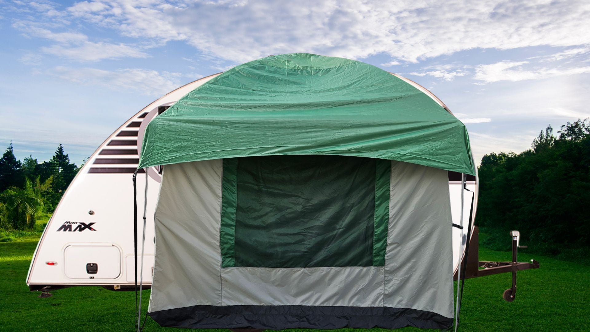 The Paha Que Custom 10x10 Side Mount Screen Room Tent is set up by a white travel trailer on grass, with trees and a partly cloudy sky, creating an ideal outdoor living space for camping and adventures.
