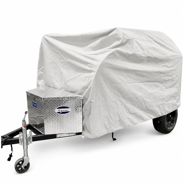 The PahaQue Wilderness Aero Teardrops Trailer Cover in gray offers top protection for small trailers with front metal toolboxes, shielding the trailer while leaving its wheels and hitch partially visible.