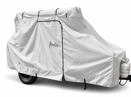 A Paha Que Custom Bean Trailer Covers Premium Durable Black Tailored Fit cover is secured over a small camper, providing full weather protection, including the attached propane tank.