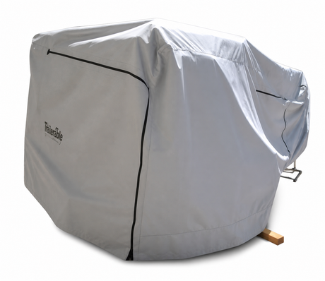 The Boreas Campers Trailer Cover Premium Protection from Elements by Paha Que Custom, in large gray with black seams, fully covers outdoor gear—leaving just a wooden block and metal handle visible—for complete weather protection.