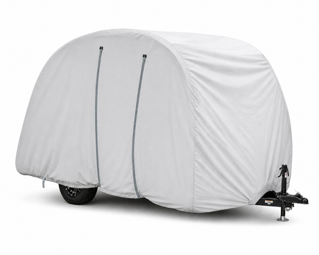 A Bushwhacker Plus Trailer Cover by Paha Que Custom, in light gray with two vertical seams, fits models 15DS and 15FK. Only the black wheel and hitch are visible below the cover against a plain white background. Made in the USA.