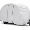 A Bushwhacker Plus Trailer Cover by Paha Que Custom, in light gray with two vertical seams, fits models 15DS and 15FK. Only the black wheel and hitch are visible below the cover against a plain white background. Made in the USA.
