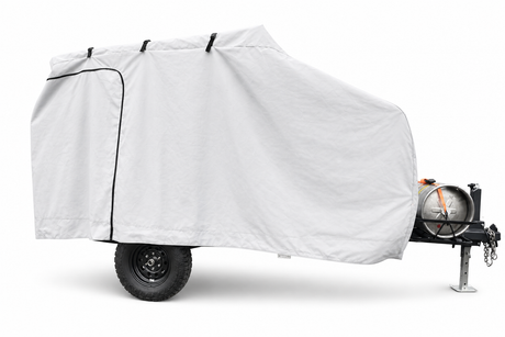 The Campinawe Trailer Cover by Paha Que Custom features heavy-duty MagnaTuff fabric that is weatherproof and breathable, shielding your small trailer while allowing access to the wheel, hitch, and front-mounted propane tank.