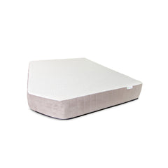 The Journey Mattress by Paha Que Custom is a white and light beige, irregularly trapezoidal economy mattress with medium firm support, displayed against a plain white background.