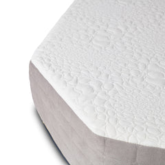 Close-up of the Journey Mattress by Paha Que Custom, a medium firm design with a white textured top featuring a pebble-like pattern, cooling gel memory foam, and light gray fabric sides.