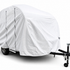 A Little Guy Mini Max FX trailer is fitted with the PahaQue Wilderness Trailer Cover, which has zippered openings and black straps, and is secured to a black metal frame with a tow hitch and wheel lock on a white background.