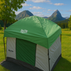 The Paha Que Custom 10x10 Side Mount Screen Room Tent is set up on grass with trees and mountains in the background, providing a scenic and comfortable space for camping and outdoor adventures.
