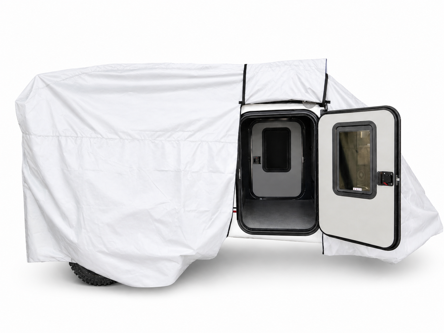 A small trailer is partially covered with the Encore Trailer Cover by Paha Que Custom, offering premium protection. The open side door reveals a dark interior with black trim, a window in the door, and visible off-road tires.