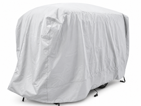 A large vehicle is fully covered with the Paha Que Custom Happier Camper HC1 Cover, a light gray custom-fit trailer cover that offers weather protection. Only the outline and part of the wheels are visible underneath.