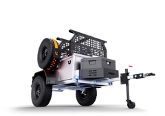 A rugged off-road utility trailer with modular storage and large tires is protected by the Paha Que Custom Ushi Chuck MAX Trailer Cover by PahaQue, featuring heavy duty MagnaTuff fabric for all-weather adventure, shown against a plain white background.