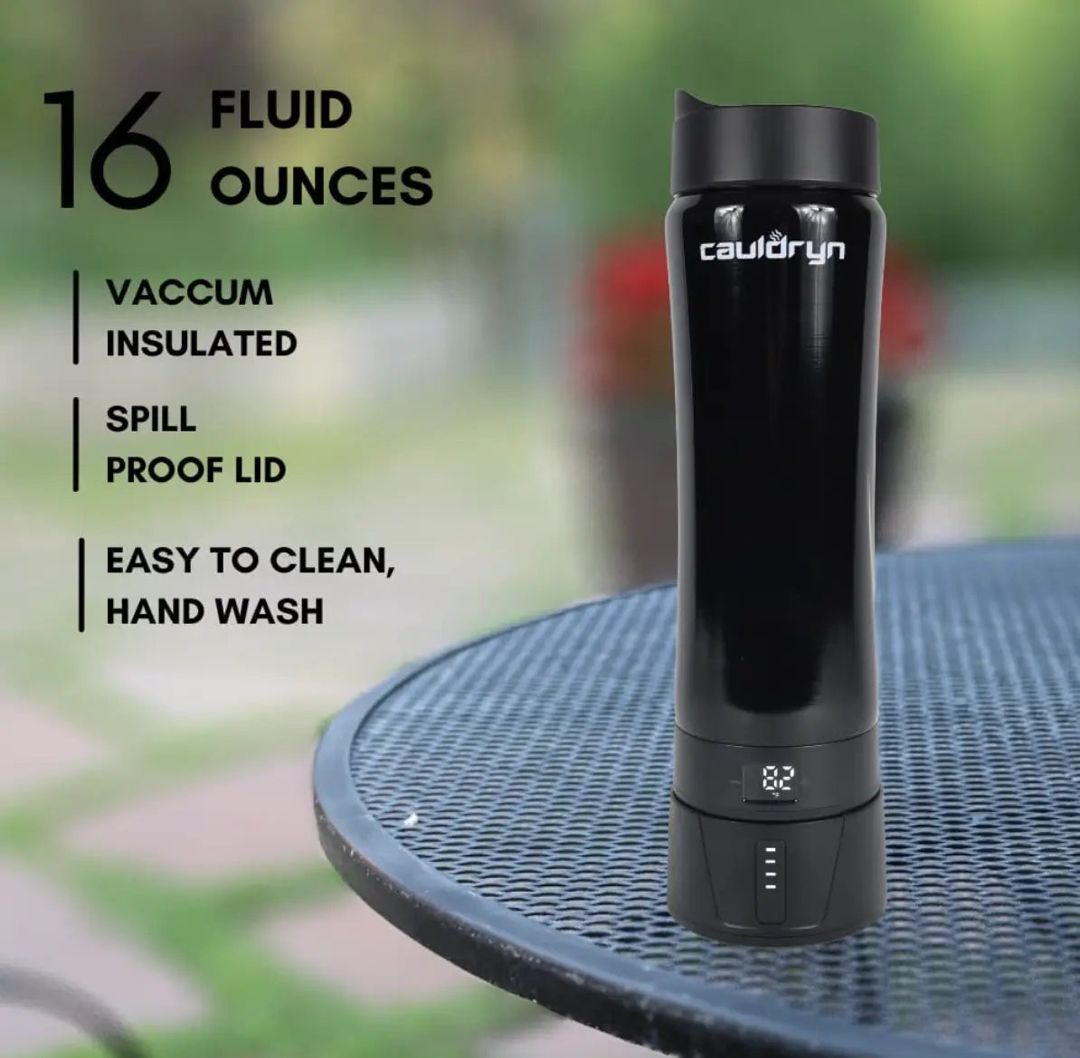 A black Cauldryn Coffee Pro by PahaQue Wilderness sits on an outdoor metal table. Its digital base shows the temperature. Features: 16oz, vacuum insulated, spill-proof lid, easy to clean (hand wash only).