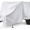A small trailer fitted with the white Sherpa Trailer Cover by PahaQue Wilderness displays its black wheels and towing hitch, with a support wheel visible at the front.