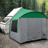 A Paha Que Custom A-Frame Trailer Side Tent, designed for Aliner, Chalet, Rockwood, and Jayco 12 & 15 box trailers, is set up at a wooded campsite with a pop-up camper surrounded by trees and dirt ground.