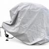 A large trailer is fully covered with the Ushi Chuck MAX Trailer Cover by PahaQue, offering heavy-duty weatherproof protection, while part of the metal hitch and wheel remain visible beneath the gray Paha Que Custom tarp.