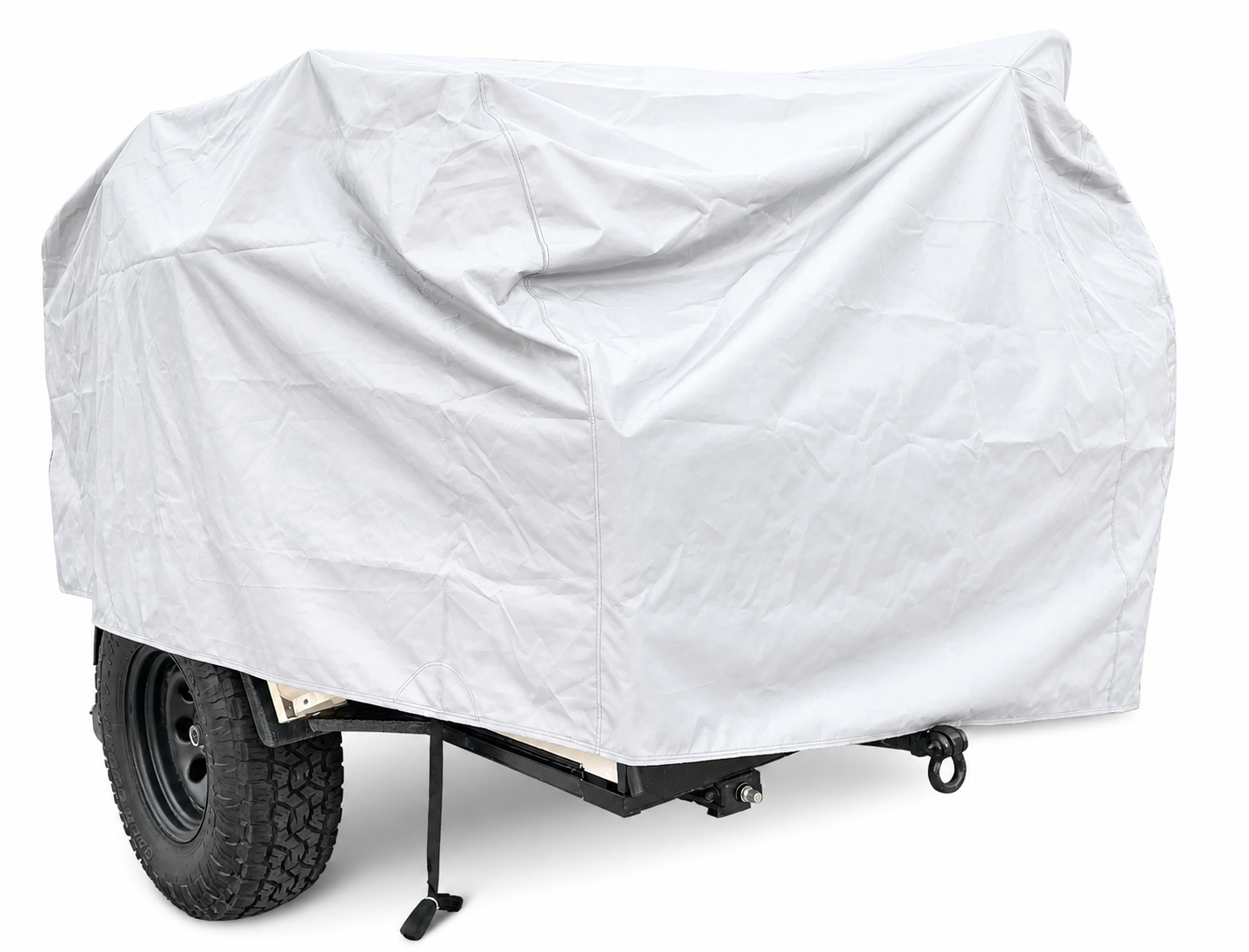 The Vintage Trailer Works XTR Cover by PahaQue Wilderness in light gray offers heavy-duty, full weather protection for your utility trailer with large tires, concealing it completely as it sits on a white surface with one support leg extended.